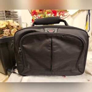 TUMI Black Backpack with Padded Straps and Multiple Compartments